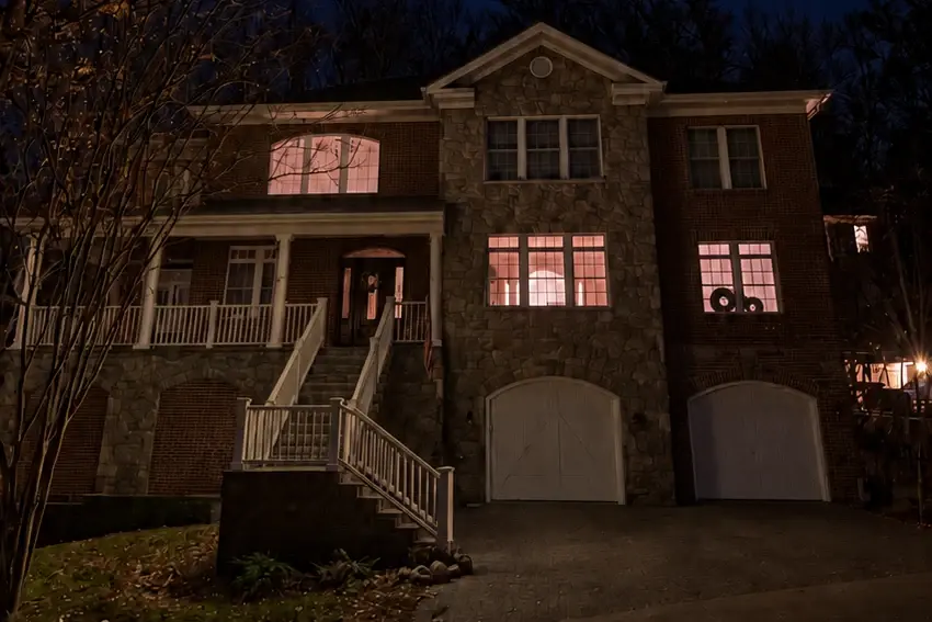 A brick and stone house at night with no holiday lights.