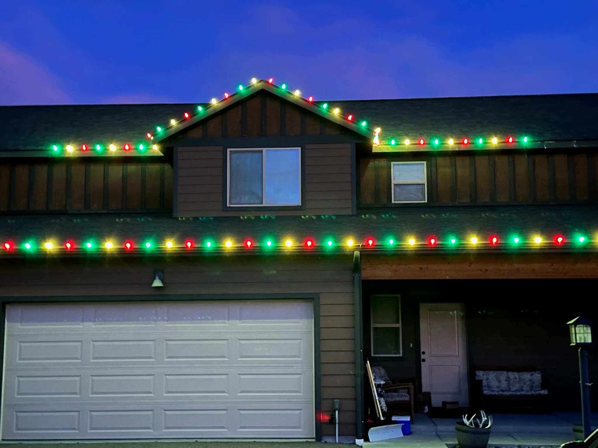 Two-story home with multicolor C9 bulbs running along every roofline.